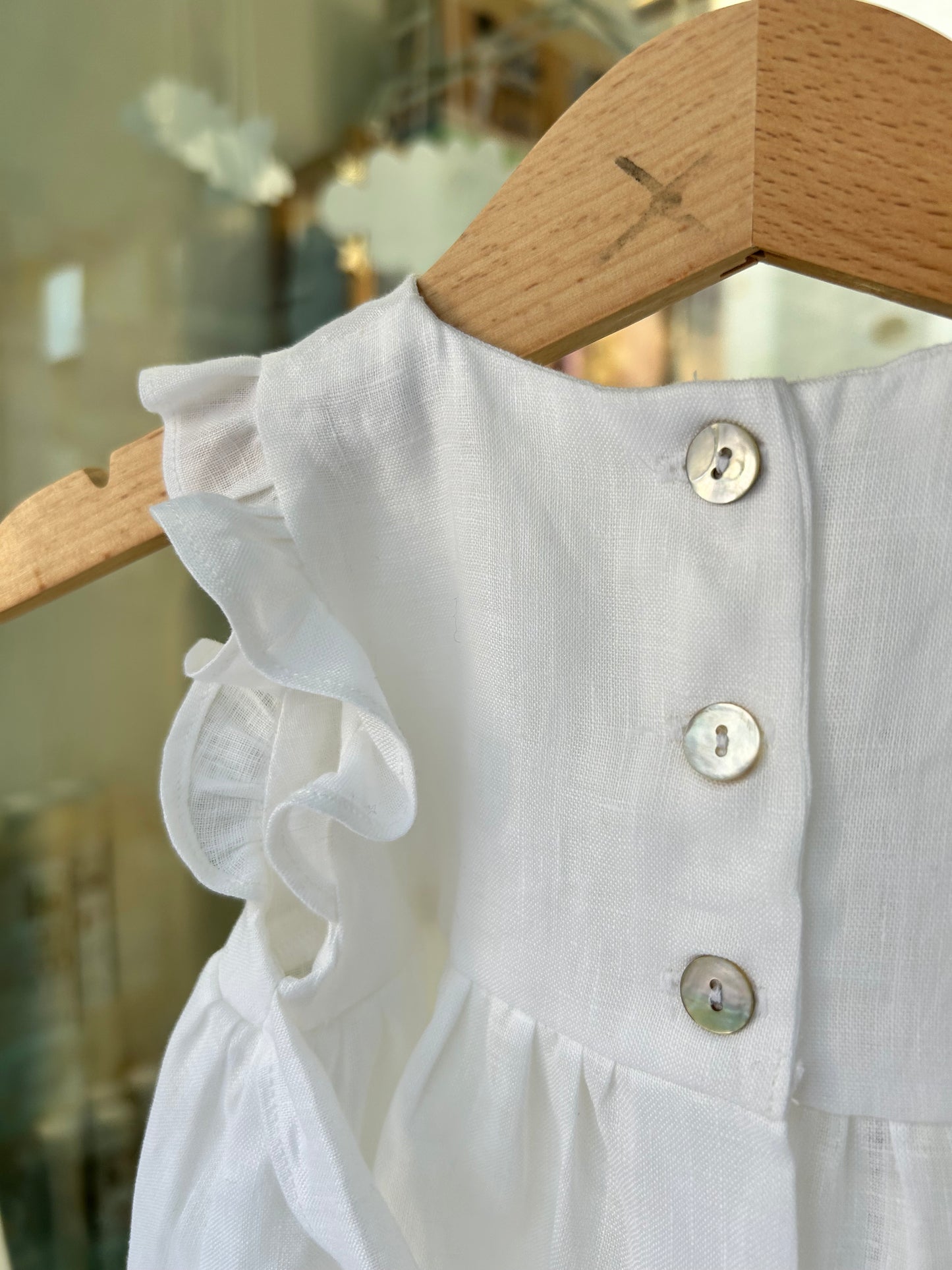 Linen romper with pink bow embroidery