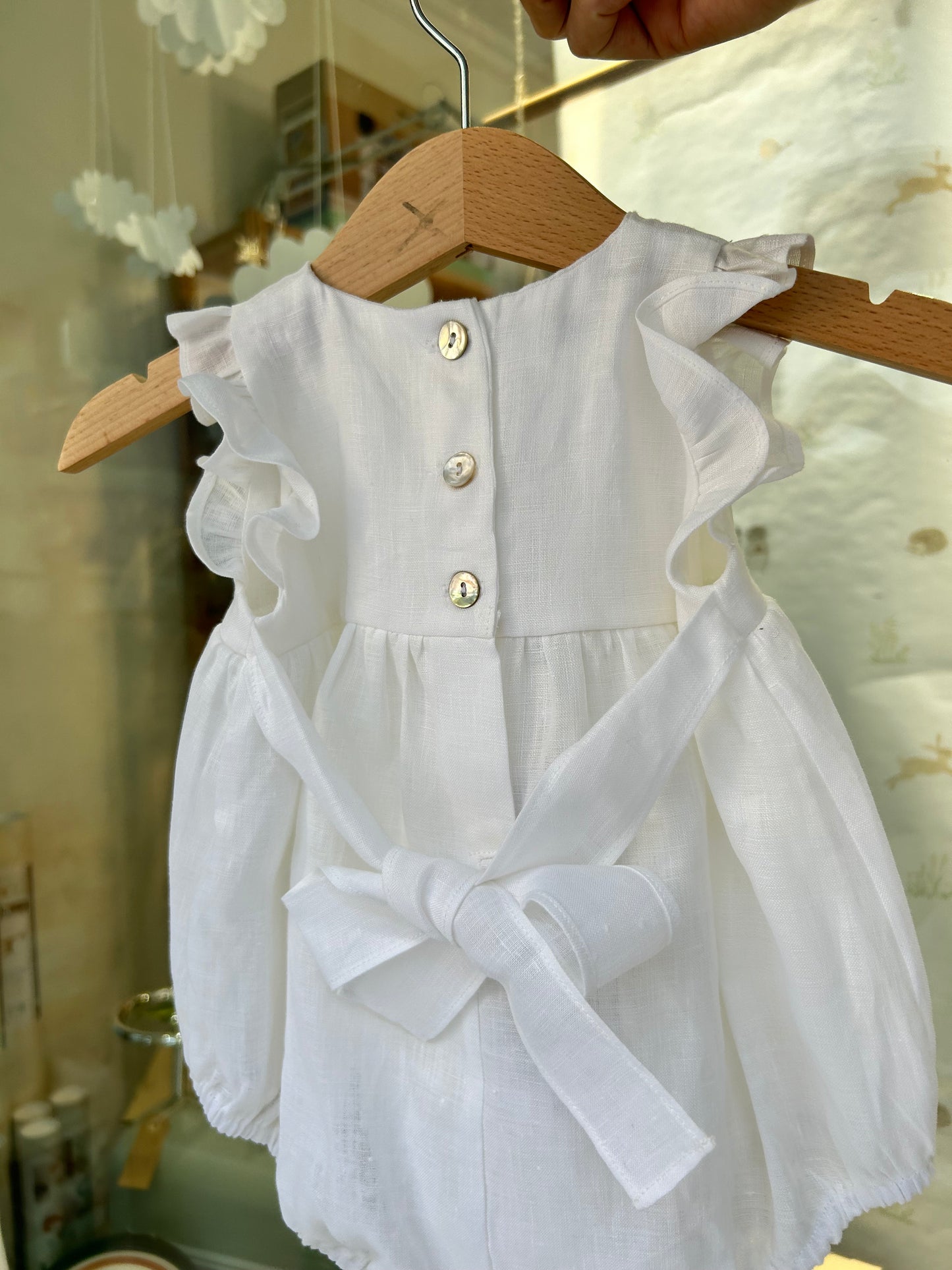 Linen romper with pink bow embroidery
