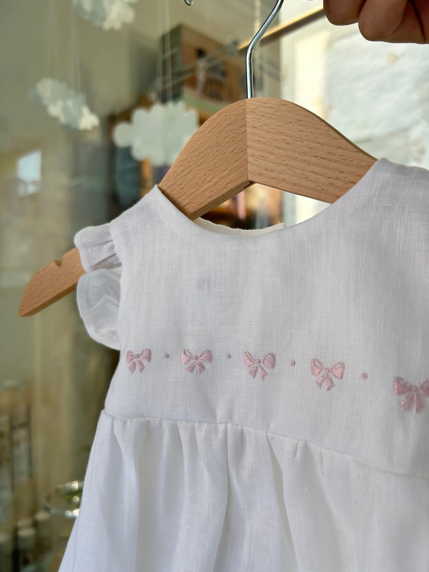 Linen romper with pink bow embroidery